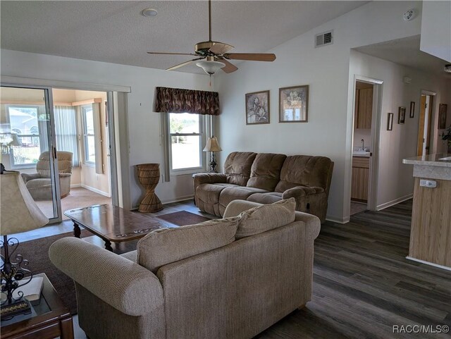 10482 S Clint Loop, Floral City, FL 34436 - living area with dark wood finished floors, a ceiling fan, baseboards, and lofted ceiling