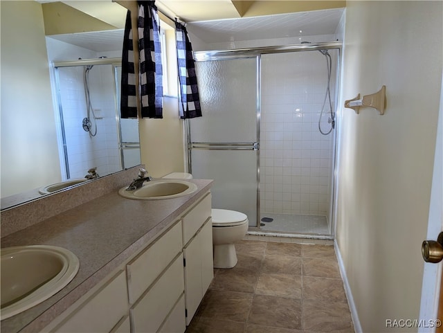 bathroom with vanity, toilet, and an enclosed shower