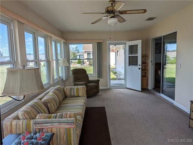 sunroom / solarium with ceiling fan and a wealth of natural light