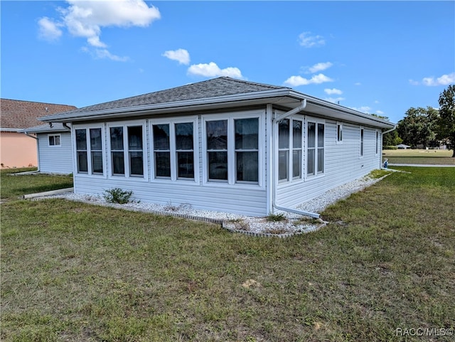 view of side of home featuring a lawn