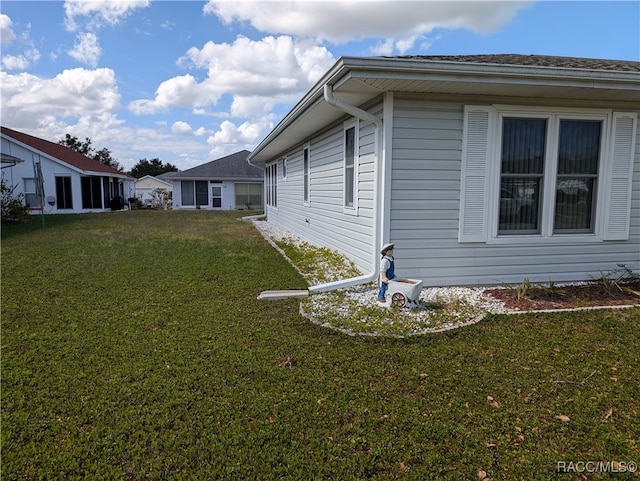 view of side of home with a lawn