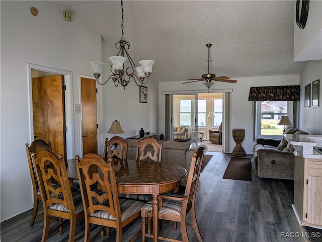 dining space with a textured ceiling, ceiling fan with notable chandelier, dark wood-type flooring, and lofted ceiling