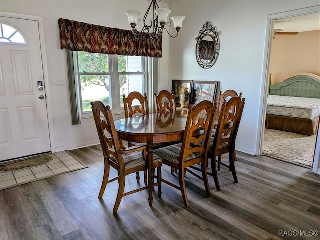 dining room featuring ceiling fan with notable chandelier, a textured ceiling, and dark hardwood / wood-style flooring