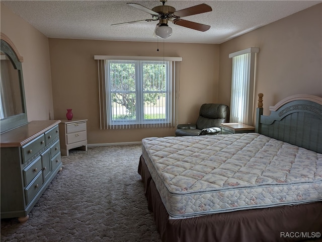 bedroom with carpet flooring, ceiling fan, and a textured ceiling