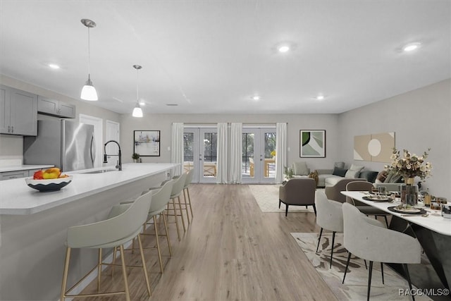 dining space featuring recessed lighting, french doors, and light wood-style floors