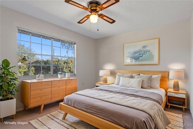 bedroom with carpet flooring, a textured ceiling, and ceiling fan