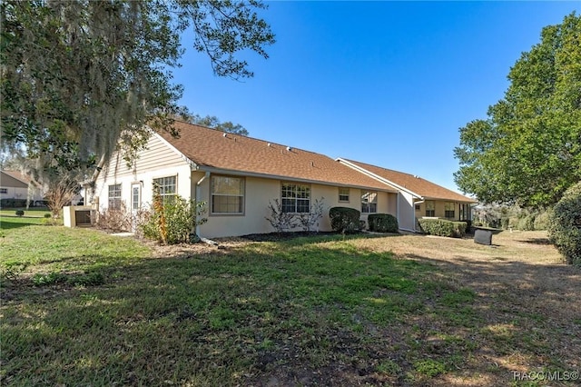 rear view of house with a lawn