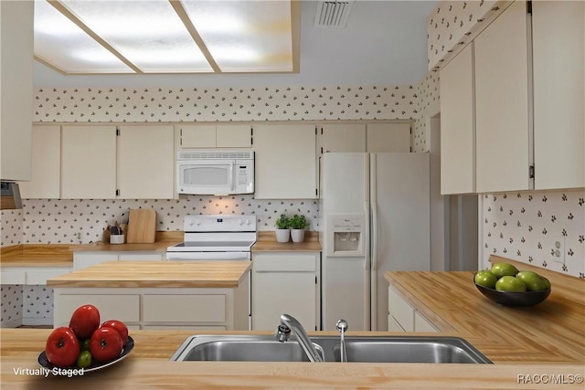 3585 N Willowtree Pt, Beverly Hills, FL 34465 - kitchen with white appliances, a sink, cream cabinetry, decorative backsplash, and wooden counters