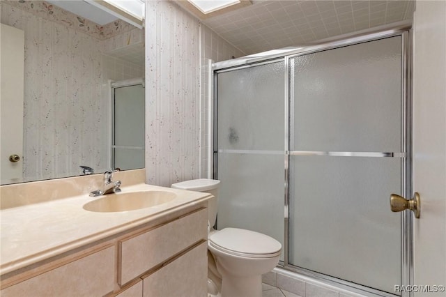 bathroom featuring tile patterned floors, vanity, toilet, and an enclosed shower