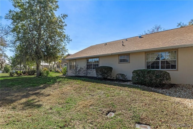 view of property exterior featuring a lawn