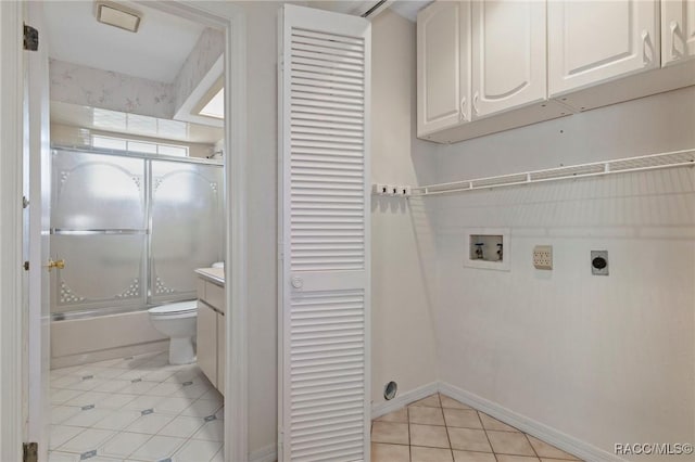 laundry area featuring cabinets, light tile patterned flooring, washer hookup, and hookup for an electric dryer