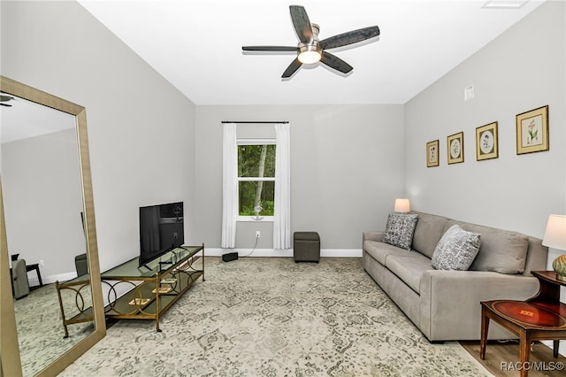 living room with ceiling fan and light hardwood / wood-style flooring