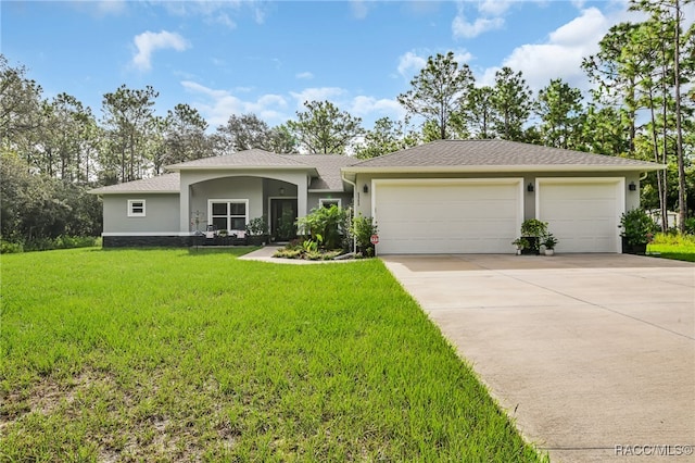 ranch-style house featuring a front yard and a garage