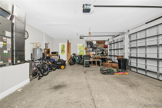 garage featuring heating unit, water heater, and a garage door opener