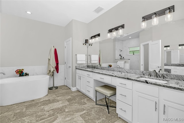 bathroom with a bath and vanity