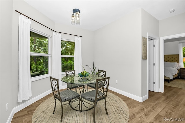 dining area featuring hardwood / wood-style floors and a notable chandelier