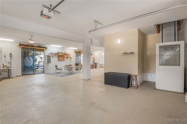 garage with electric panel, ceiling fan, and a garage door opener