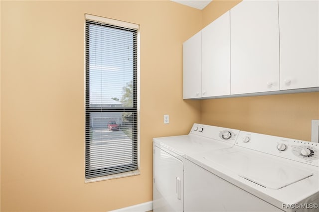 laundry area with cabinets and washing machine and dryer