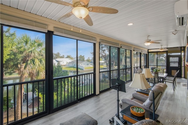 sunroom / solarium featuring ceiling fan