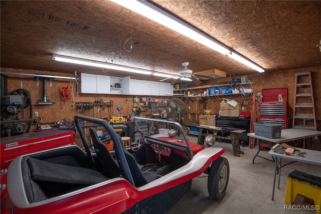 garage with a workshop area and ceiling fan