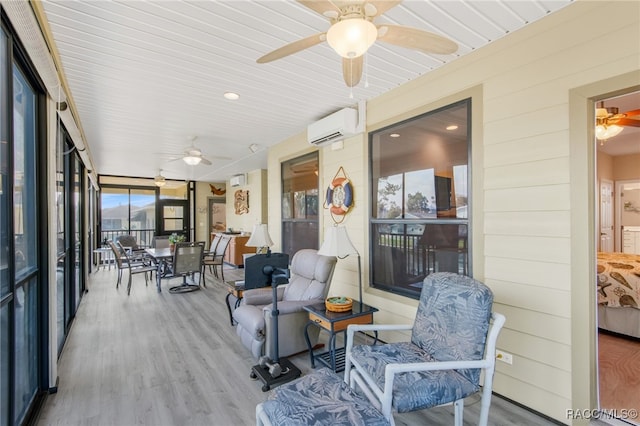 sunroom with ceiling fan and a wall mounted air conditioner