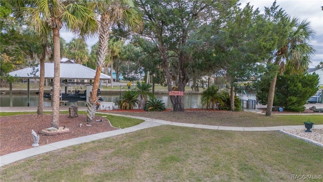 view of yard featuring a boat dock and a water view