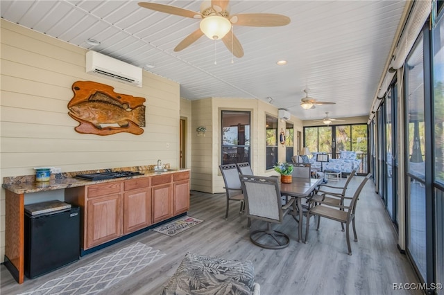 sunroom / solarium featuring a wall mounted AC and ceiling fan