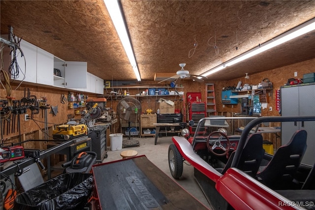 garage with a workshop area and ceiling fan