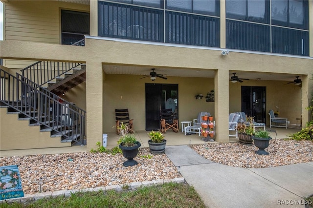 property entrance with a patio and ceiling fan