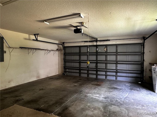 garage featuring a garage door opener and electric panel