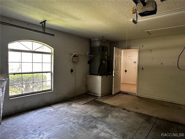garage with a garage door opener and heating unit
