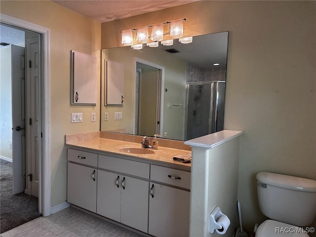 bathroom featuring tile patterned flooring, visible vents, toilet, vanity, and a stall shower