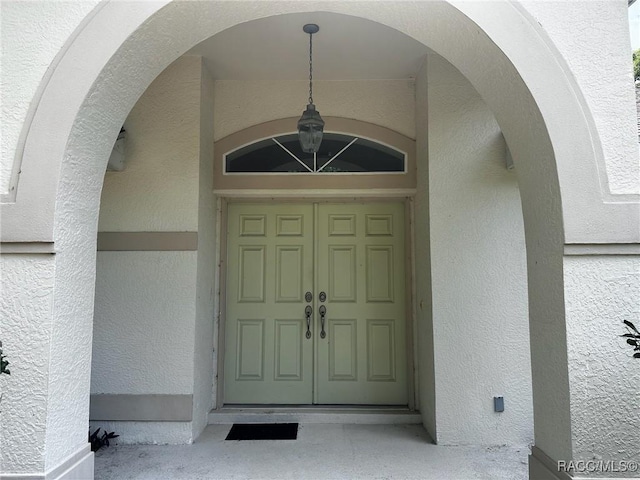 doorway to property with stucco siding