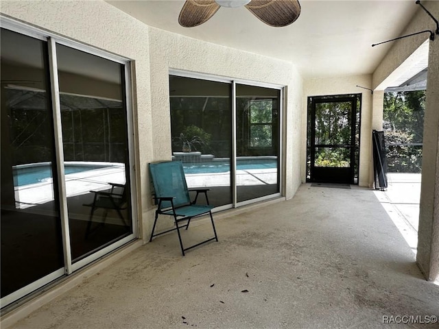 view of patio with an outdoor pool and ceiling fan