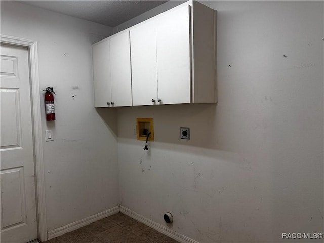 clothes washing area with baseboards, washer hookup, hookup for an electric dryer, and cabinet space