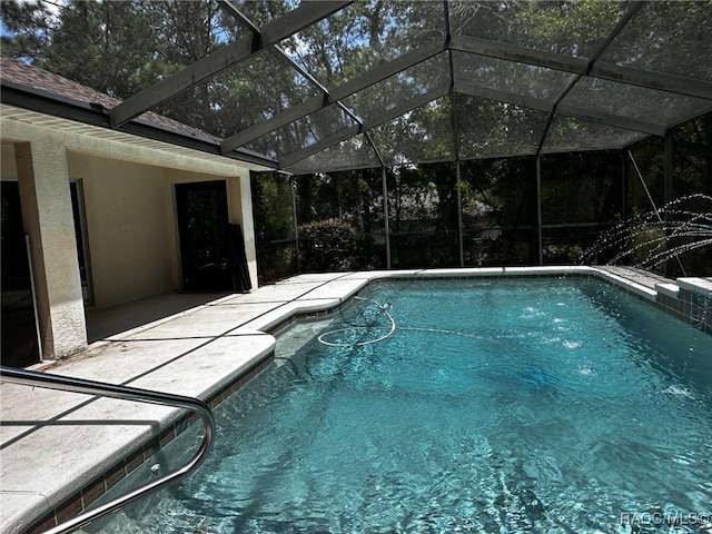 outdoor pool featuring a lanai and a patio
