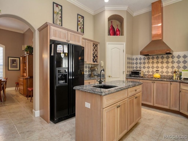 kitchen with black appliances, decorative backsplash, sink, a kitchen island with sink, and range hood