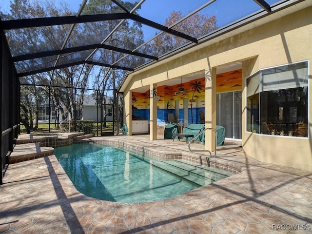 view of swimming pool with a lanai, ceiling fan, and a patio