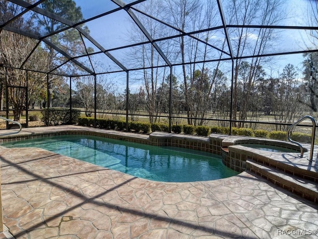 view of pool featuring an in ground hot tub, a lanai, and a patio