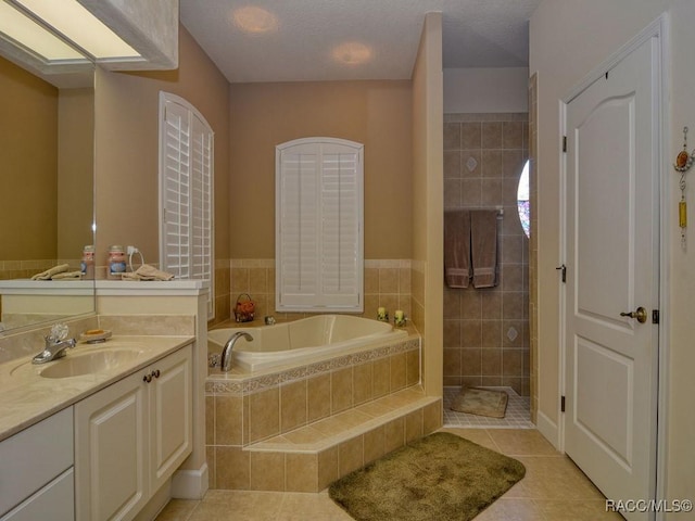 bathroom with vanity, tile patterned flooring, and independent shower and bath