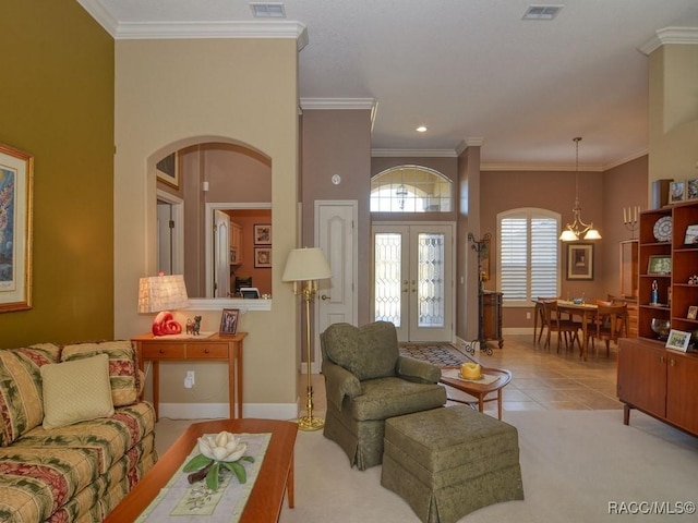 living room featuring ornamental molding, french doors, and light tile patterned flooring