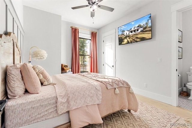 bedroom with ceiling fan, connected bathroom, and light wood-type flooring