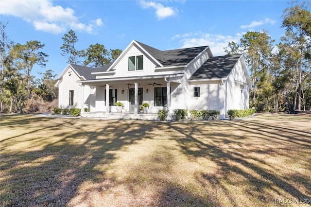 modern inspired farmhouse with covered porch and a front lawn