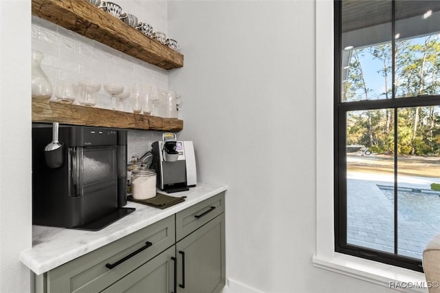 bar with plenty of natural light and gray cabinets