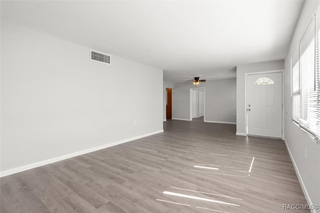 interior space with ceiling fan and light hardwood / wood-style flooring