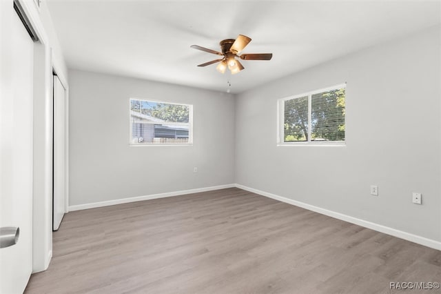 unfurnished bedroom featuring ceiling fan and light wood-type flooring