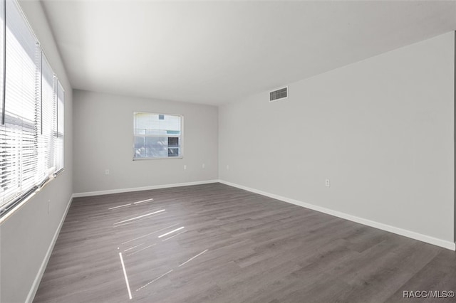 spare room featuring dark hardwood / wood-style flooring