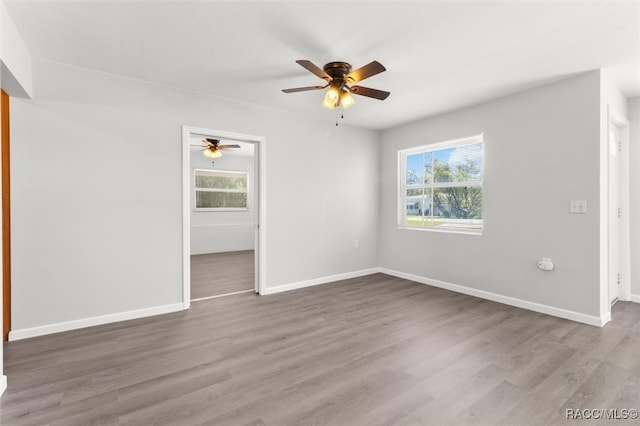 spare room with ceiling fan and wood-type flooring