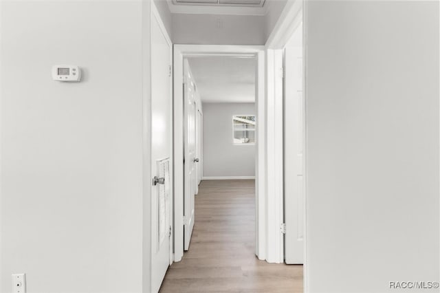 hallway with light hardwood / wood-style flooring