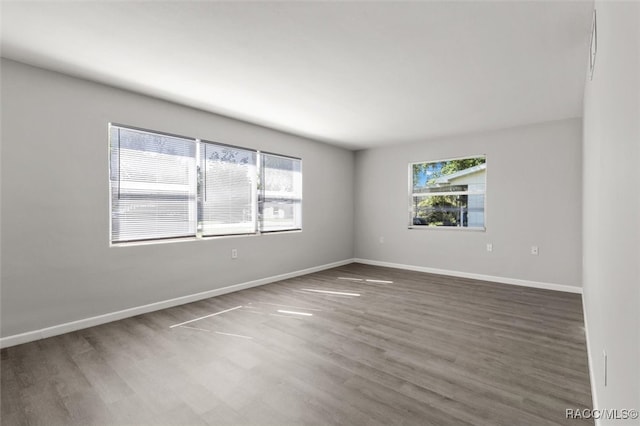 empty room featuring dark wood-type flooring